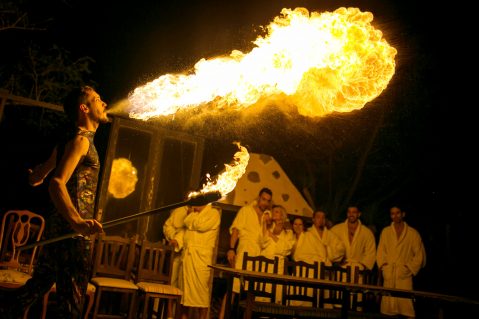 Pic shows: Fire show in the restaurant. By Ana Lacasa A new nude restaurant on one of Spain's most popular holiday islands is set to become a hit with British holidaymakers. The Innato Tenerife eatery - which opened this week - encourages diners to peel off for a mouth-watering menu in what owners describe as an "orgasmic atmosphere." Diners have to check in their smartphones and cameras to spare other customers' blushes before they are led to a changing room to strip down to a bathrobe. Then they walk to their candlelit table where they take off the robes and soak up the intimate atmosphere. Discreet bamboo partitions screen tables from each other so customers are able to let themselves go without the fear of being seen. Specials include the "aphrodisiac menu" served on male and female models who serve as human tables, with just the odd fig or vine leaf to cover their modesty. Especially popular is the 'Happy Endings' dessert, where the models smother themselves in melted chocolate sauce so diners can dip their strawberries. Other favourites on the 150-EUR (129-GBP) a head menu include a dish called Pulp Fiction, with octopus, potato and paprika, and Olindo Lobster, with lobster mango, mustard and brandy. Owner Tony de Leonardis - who was inspired by London's The Bunyadi pop-up restaurant - says customers at his venue in San Isidro soon get used to eating in the buff. And some, reports local media, have revealed that the experience even revives their love lives. (ends)